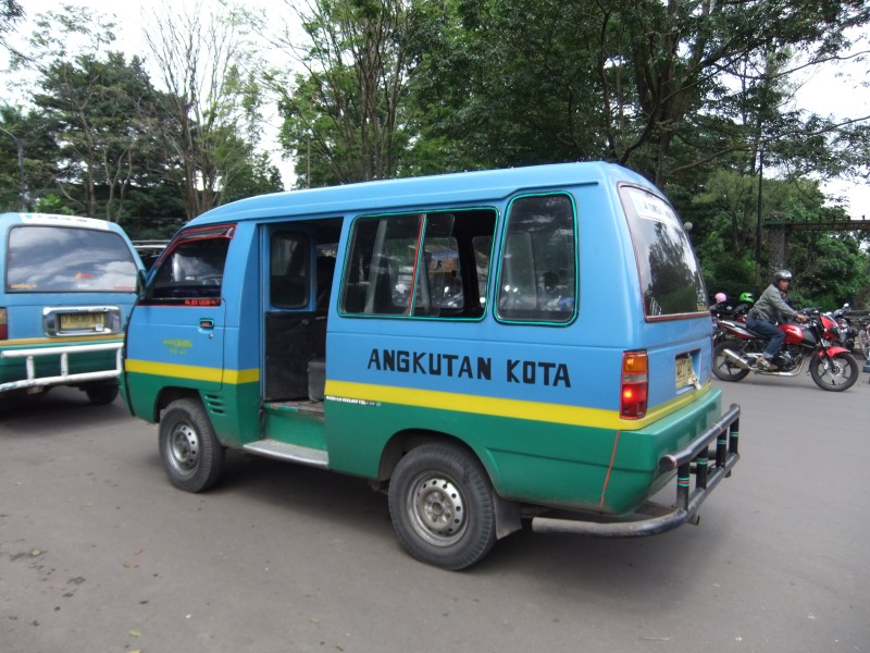 Angkot in Bandung. The blue-yellow-green colour scheme identifies it is an angkot on the Sadang Serang-Caringin route.